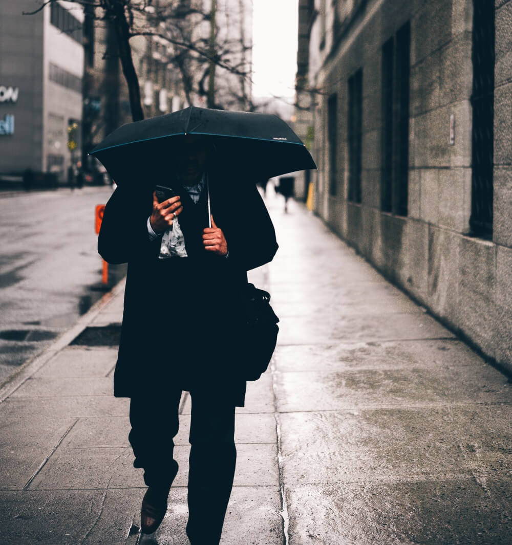 man-in-rain-under-umbrella.jpg